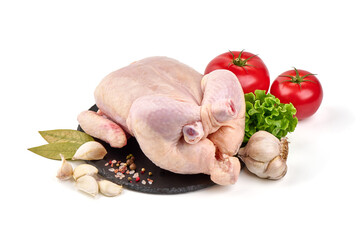 Raw whole chicken with condiments and vegetables, isolated on white background.