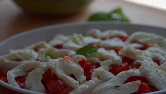 preparing Paccheri pasta with fresh tomatoes and mozzarella cheese, basil