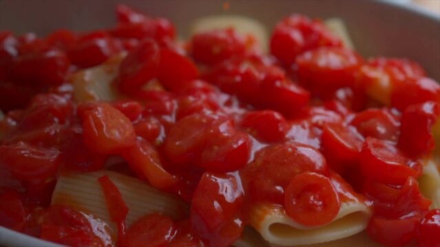 preparing Paccheri pasta with fresh cherry tomatoes 