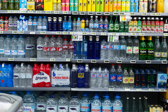 BARCELONA, SPAIN - FEBRUARY 17, 2020: Shelves with bottled still and carbonated water in spanish store
