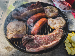 There is meat on the grill. Barbecue for the holiday. American Weekend. Soft focus