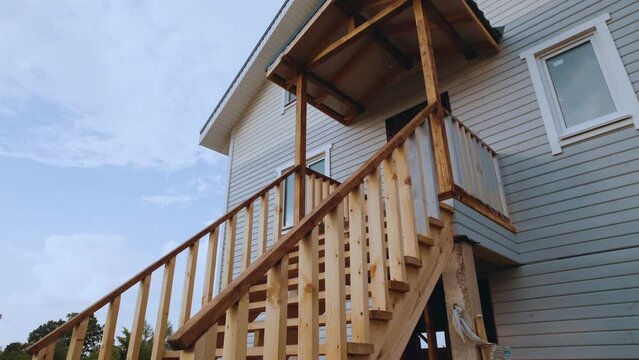 The staircase of a frame house at sunset
