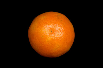 tangerine lies on a black background