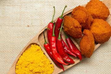 Traditional Brazilian black-eyed pea dumplings with red peppers and palm oil farofa - Typical  food from Bahia