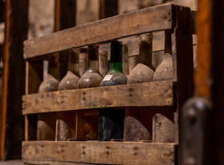wine bottles aging upside down in a wine cellar