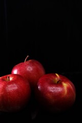 red apples on black background