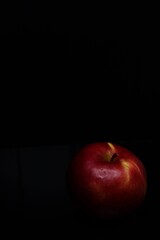 red apple on black background