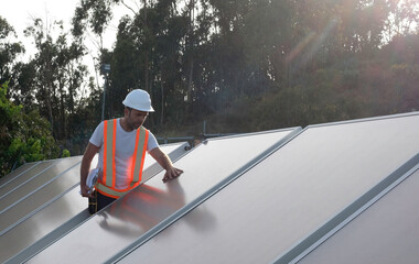 Engineer checking the installation and operation of solar hot water panels.