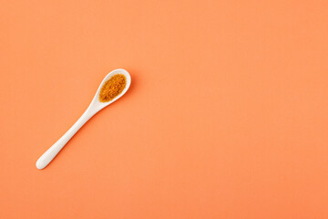 Organic brown sugar in the ceramic spoon - Saccharum officinarum
