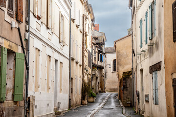 Fototapeta na wymiar Face of medieval houses in a narrow street of a typical french medieval village and city, bergerac, in France, in the region of Dordogne and Perigord, with a typical Southwestern French architecture