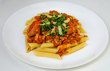 spaghetti bolognese on a plate, pasta with sauce and cheese, lunch and orange juice