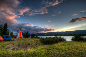 lighthouse at sunset with pink clouds