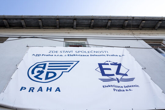 PRAGUE, CZECHIA - NOVEMBER 6, 2019: AZD Praha & Elektrizace Zeleznic logo in front of one of a train construction site. AZD Praha is a firm specialized in railway engineering & project development.