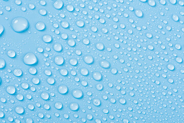 close up of water drops on blue background.