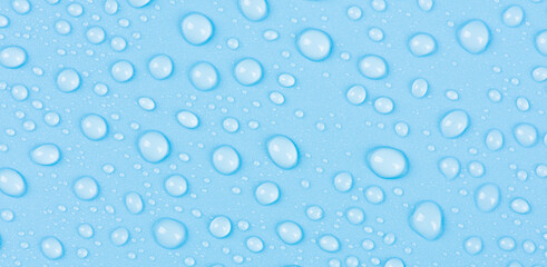 close up of water drops on blue background.