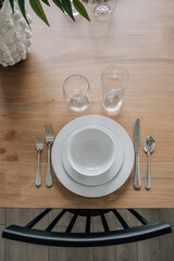 White place setting on wood table