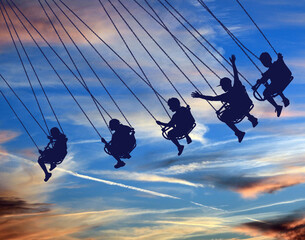 Young people are seen riding a swing chair ride with a beautiful sky in the background in this 3-d illustration. © Rob Goebel