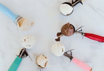 Ice cream scoops on a white marble background, minimalist, vintage scoops