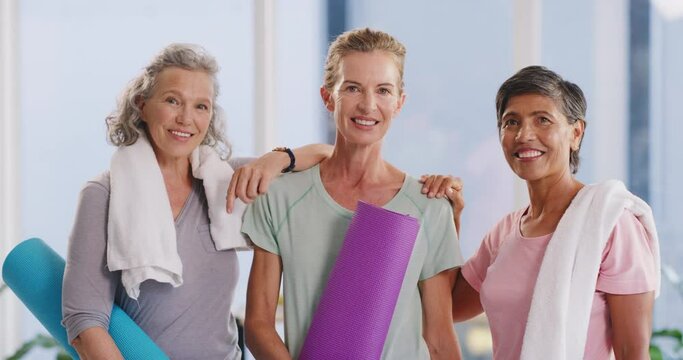 Active mature women ready for a yoga session in a fitness studio. Portrait of a diverse group of confident and smiling ladies feeling cheerful, content and excited to enjoy a relaxing workout class