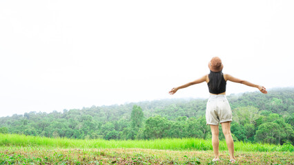 Asian Girl in green meadow of nature river happy holiday. Pleasure scene.Young woman watching landscape, posing outdoor. Active lifestyle concept. Arms up.