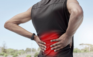 Closeup shot of a young male athlete suffering with back pain while working out. Superimposed cgi...