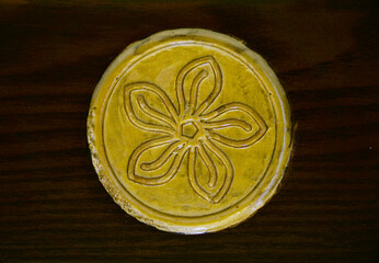 Crafted golden door knob detailed with flower imprint in background