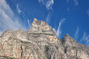 Copy space with view of Table Mountain in Cape Town South Africa against a cloudy blue sky background. Scenic landscape and beautiful panoramic of an iconic landmark and famous travel destination