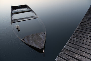 Boat under water at the lake. Sunken boat