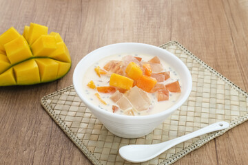 Mango Cheese Milk, a dessert made from jelly, nata de coco, basil seed, sweet mango, cream cheese and milk.
