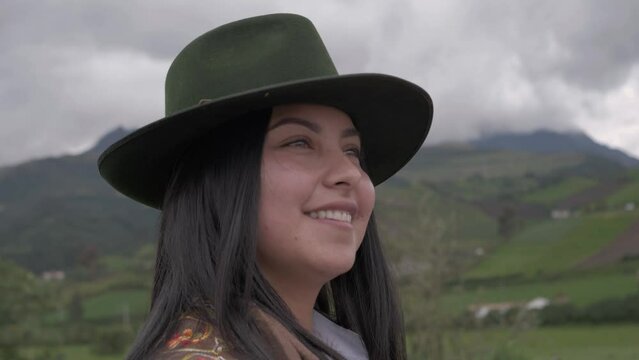 Beautiful latina cowgirl on the farm smiling.