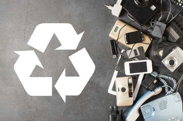 Old electronic devices on a dark background. The concept of recycling and disposal of electronic waste.