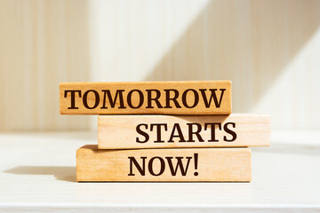 Wooden blocks with words 'Tomorrow Starts Now'.