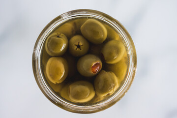  pantry jar with green stuffed olives in close-up, simple staple ingredients