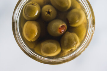  pantry jar with green stuffed olives in close-up, simple staple ingredients