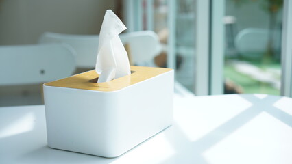 Tissue paper in napkin paper wooden white box on table. White sheet paper for cleaning face....
