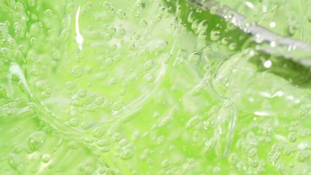 Green aloe vera cosmetic serum gel texture, transparent fluid, macro facial mask