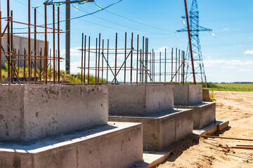 Monolithic reinforced concrete foundations for the construction of a residential building. Grillage at the construction site. Construction pit with foundations.