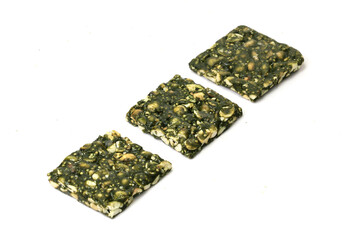 Immunity Booster Spirulina Chikki with groundnut and Jaggery isolated on white background