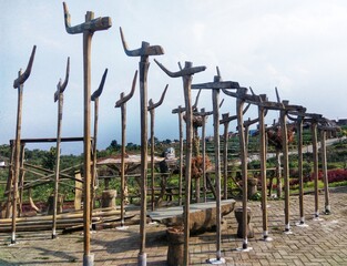 Decoration of antique wooden poles and chairs in the outdoor garden