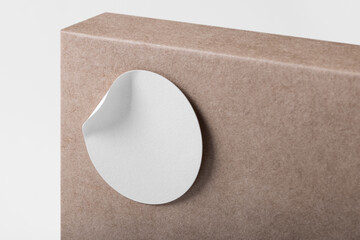 Rounded sticker mockup template on box package with copy space for your logo or graphic design