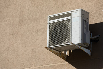 old outdoor air conditioner unit hanging outside the building