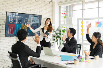 Asian business woman present business strategy plan to corporate colleagues in the meeting room. Group of Asian businesspeople meeting business plan on white board in the office.