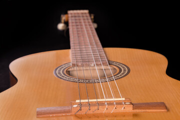 Obraz premium Fragment of soundboard of wooden acoustic guitar in selective focus
