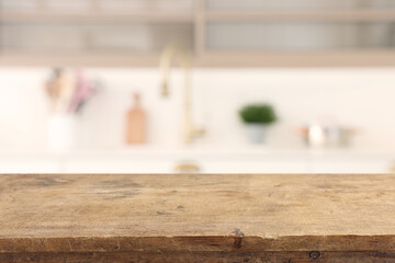 empty table board and defocused modern kitchen background. product display concept