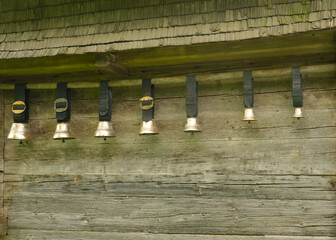 A picture row of Swiss cow bell also known as Treichel hanging at the wall.