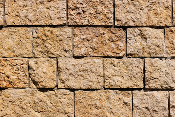 The wall is lined with rectangular stone blocks with a rough textured surface.