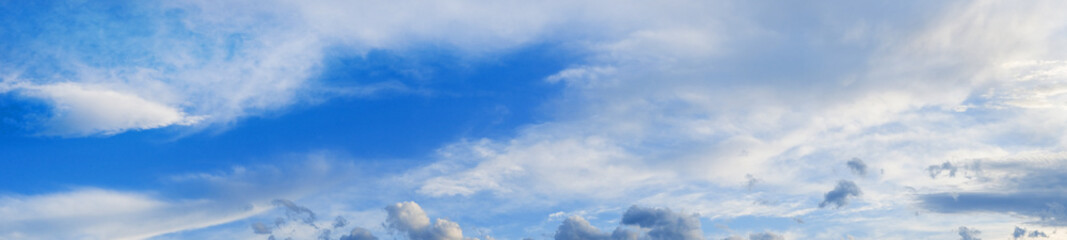 Blue sky with beautiful clouds and sunlight, banner format