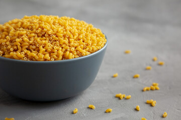 Dry Organic Pasta Coquillettes in a Bowl, side view.
