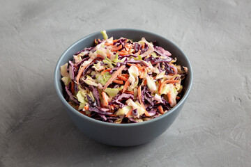 Homemade Coleslaw with Cabbage and Carrots in a Bowl, side view.