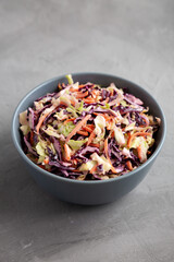 Homemade Coleslaw with Cabbage and Carrots in a Bowl, side view.